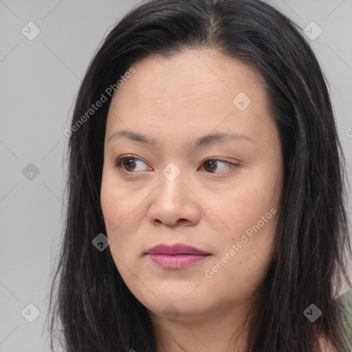 Joyful asian young-adult female with long  brown hair and brown eyes