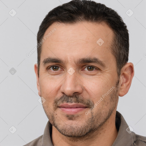 Joyful white adult male with short  brown hair and brown eyes