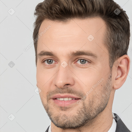 Joyful white adult male with short  brown hair and brown eyes