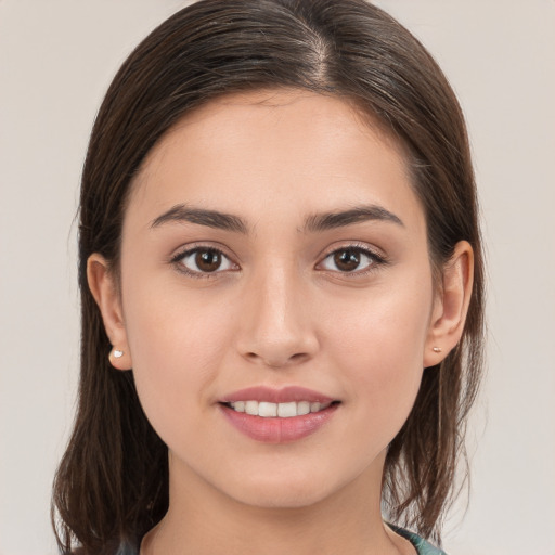 Joyful white young-adult female with long  brown hair and brown eyes