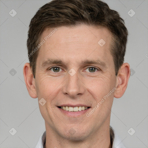 Joyful white adult male with short  brown hair and grey eyes