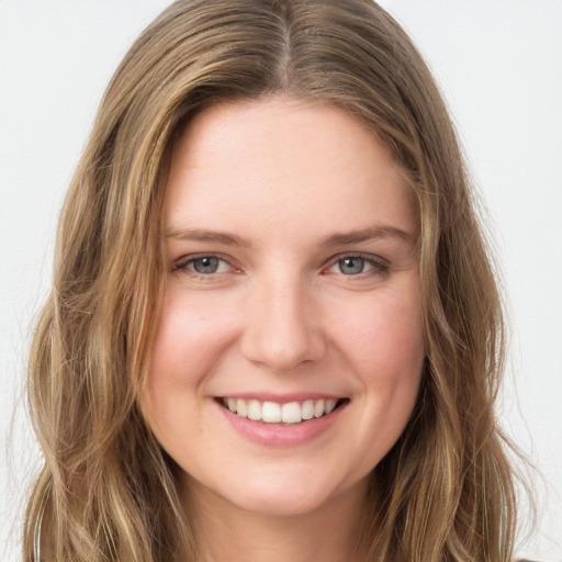 Joyful white young-adult female with long  brown hair and green eyes