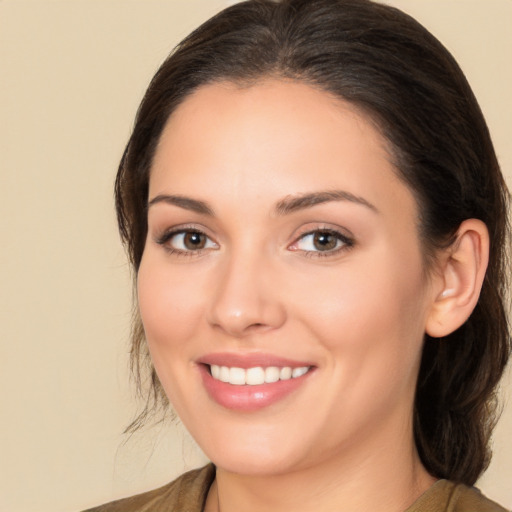 Joyful white young-adult female with medium  brown hair and brown eyes