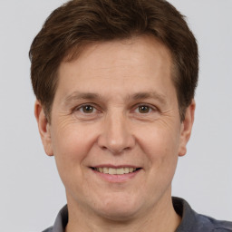 Joyful white adult male with short  brown hair and brown eyes