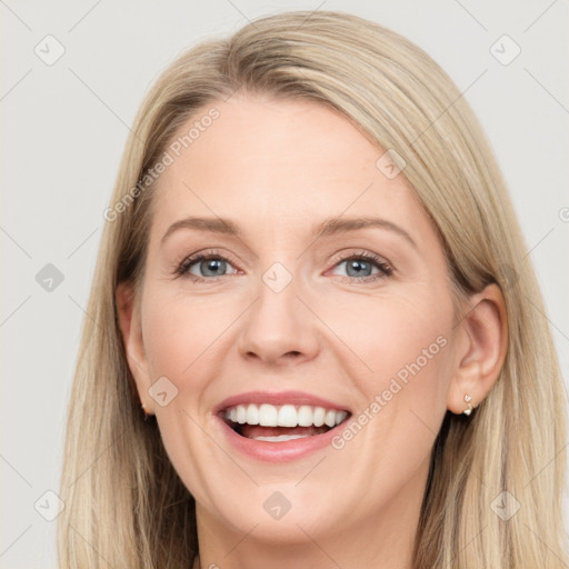 Joyful white adult female with long  brown hair and grey eyes