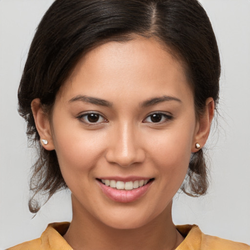 Joyful white young-adult female with medium  brown hair and brown eyes