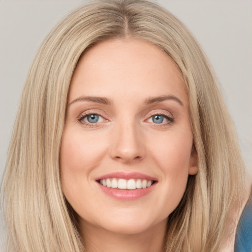 Joyful white young-adult female with long  brown hair and blue eyes