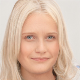 Joyful white young-adult female with long  blond hair and blue eyes