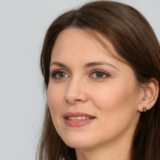 Joyful white young-adult female with long  brown hair and brown eyes