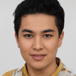 Joyful asian young-adult male with short  brown hair and brown eyes