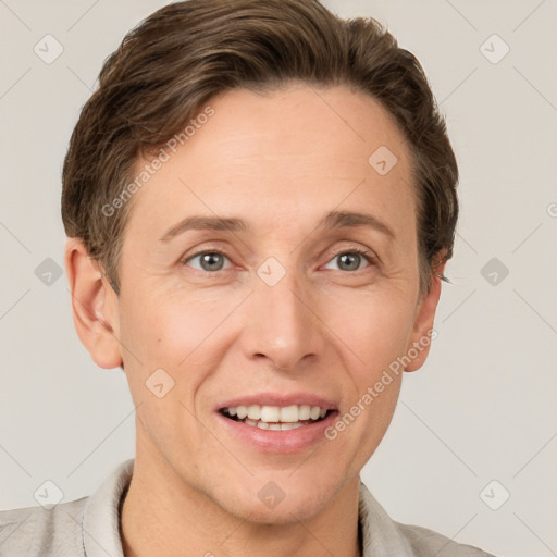 Joyful white adult male with short  brown hair and grey eyes