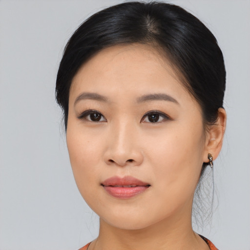 Joyful asian young-adult female with medium  black hair and brown eyes