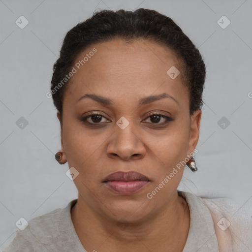 Joyful black adult female with short  black hair and brown eyes