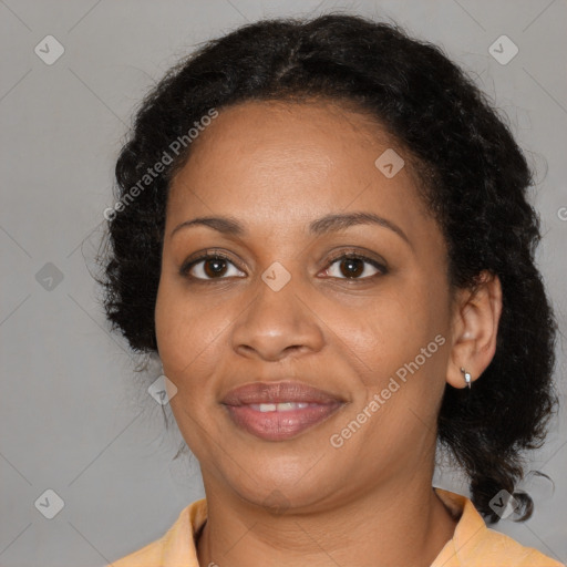 Joyful black adult female with medium  brown hair and brown eyes