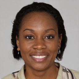 Joyful black young-adult female with medium  brown hair and brown eyes