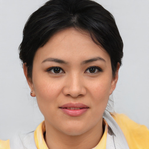Joyful asian young-adult female with medium  brown hair and brown eyes