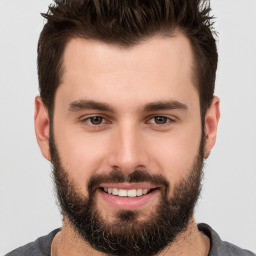 Joyful white young-adult male with short  brown hair and brown eyes