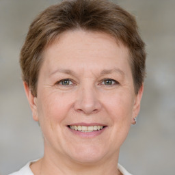 Joyful white adult female with short  brown hair and grey eyes