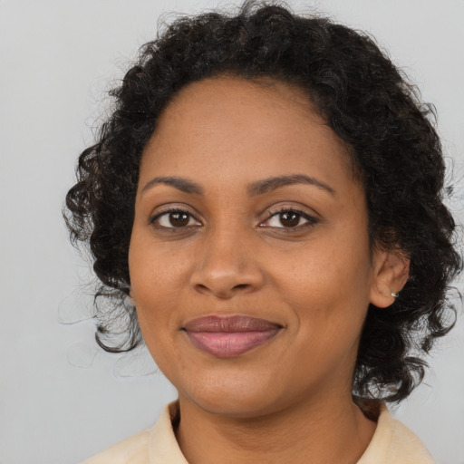Joyful black young-adult female with medium  brown hair and brown eyes