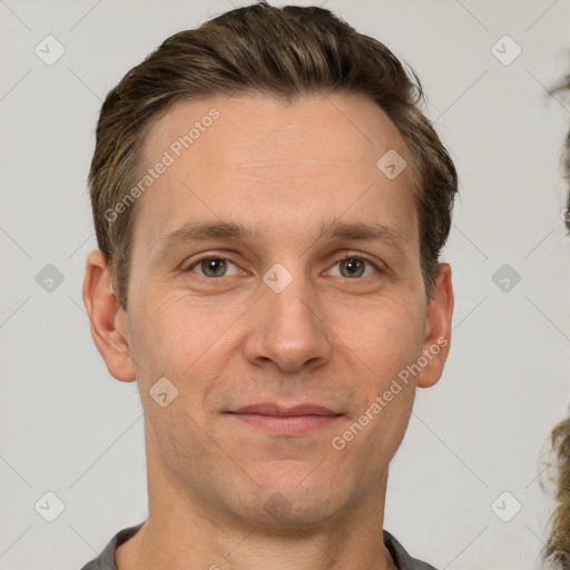 Joyful white adult male with short  brown hair and grey eyes