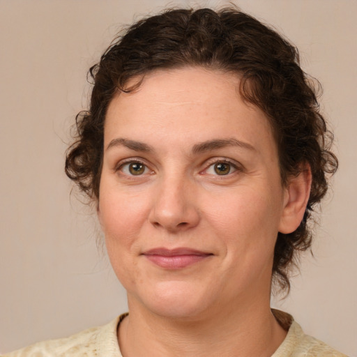 Joyful white young-adult female with medium  brown hair and green eyes