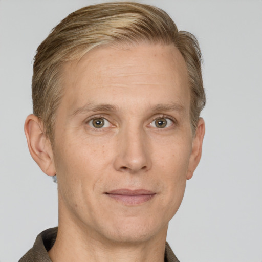 Joyful white adult male with short  brown hair and grey eyes