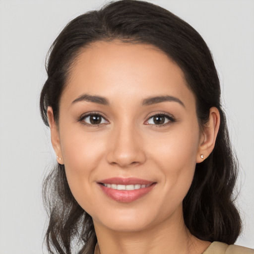 Joyful white young-adult female with long  brown hair and brown eyes