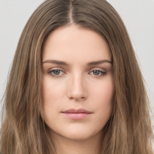 Neutral white young-adult female with long  brown hair and brown eyes