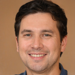 Joyful white adult male with short  brown hair and brown eyes