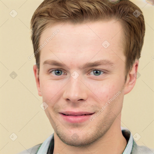 Joyful white young-adult male with short  brown hair and grey eyes