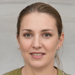 Joyful white young-adult female with medium  brown hair and grey eyes