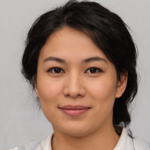 Joyful asian young-adult female with medium  brown hair and brown eyes