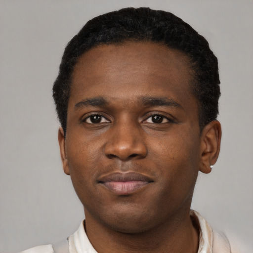Joyful black young-adult male with short  brown hair and brown eyes