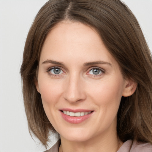 Joyful white young-adult female with medium  brown hair and grey eyes