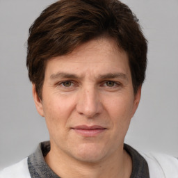 Joyful white adult male with short  brown hair and grey eyes