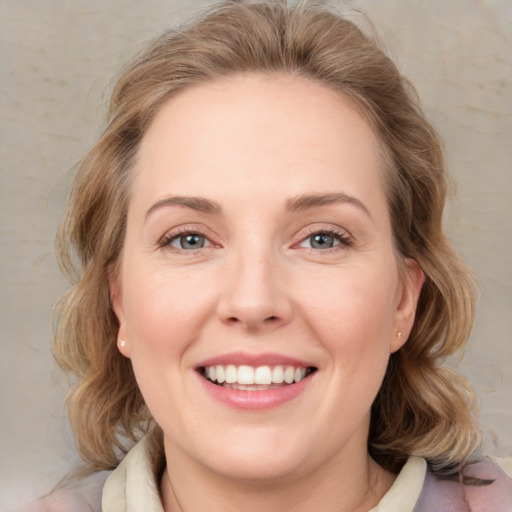 Joyful white young-adult female with medium  brown hair and green eyes