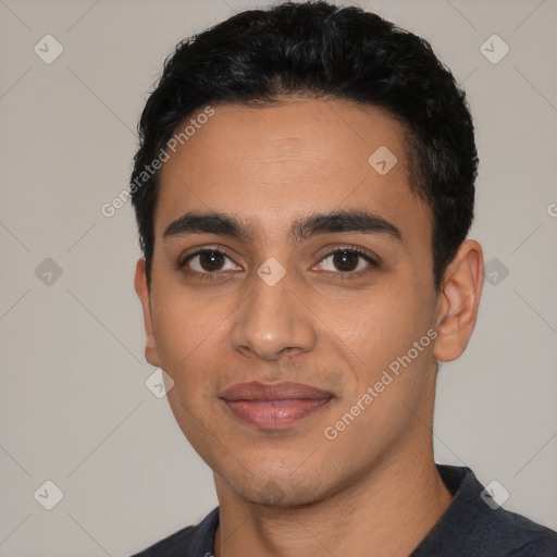 Joyful latino young-adult male with short  black hair and brown eyes