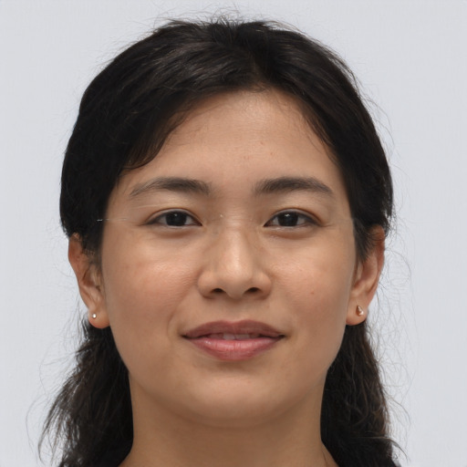 Joyful asian young-adult female with long  brown hair and brown eyes
