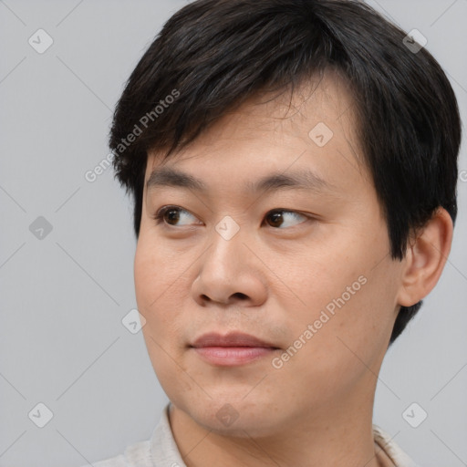 Joyful asian young-adult male with short  black hair and brown eyes