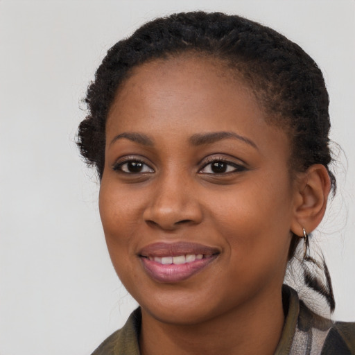 Joyful black young-adult female with long  brown hair and brown eyes