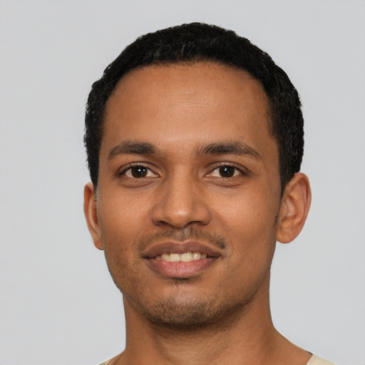 Joyful black young-adult male with short  black hair and brown eyes