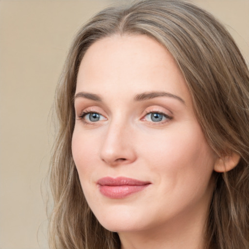 Joyful white young-adult female with long  brown hair and blue eyes