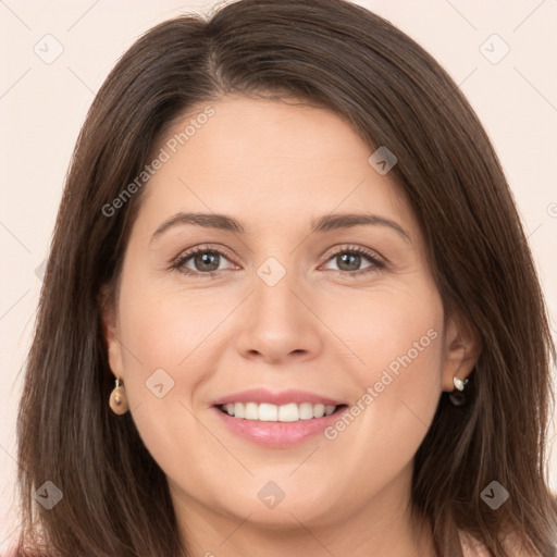 Joyful white young-adult female with long  brown hair and brown eyes