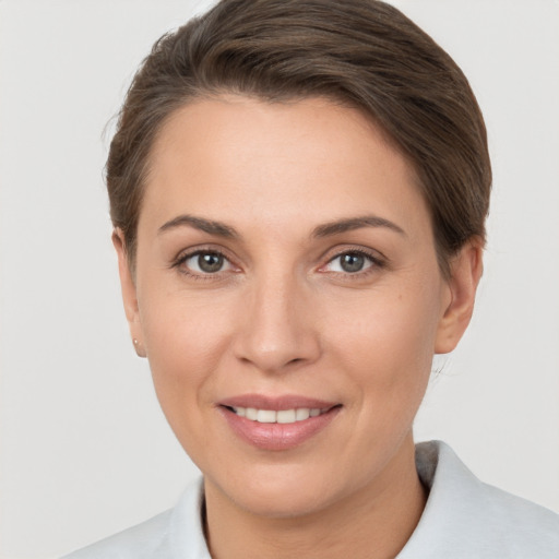 Joyful white adult female with short  brown hair and brown eyes