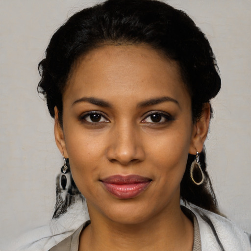 Joyful black young-adult female with medium  black hair and brown eyes