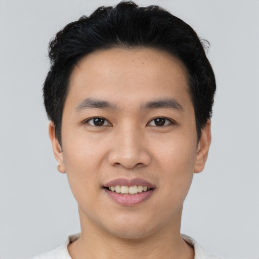 Joyful asian young-adult male with short  black hair and brown eyes