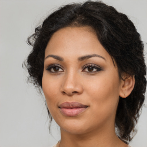 Joyful latino young-adult female with medium  brown hair and brown eyes