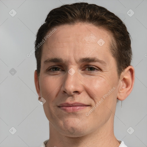 Joyful white adult male with short  brown hair and brown eyes