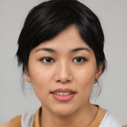 Joyful asian young-adult female with medium  black hair and brown eyes