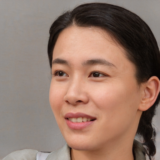 Joyful asian young-adult female with medium  brown hair and brown eyes